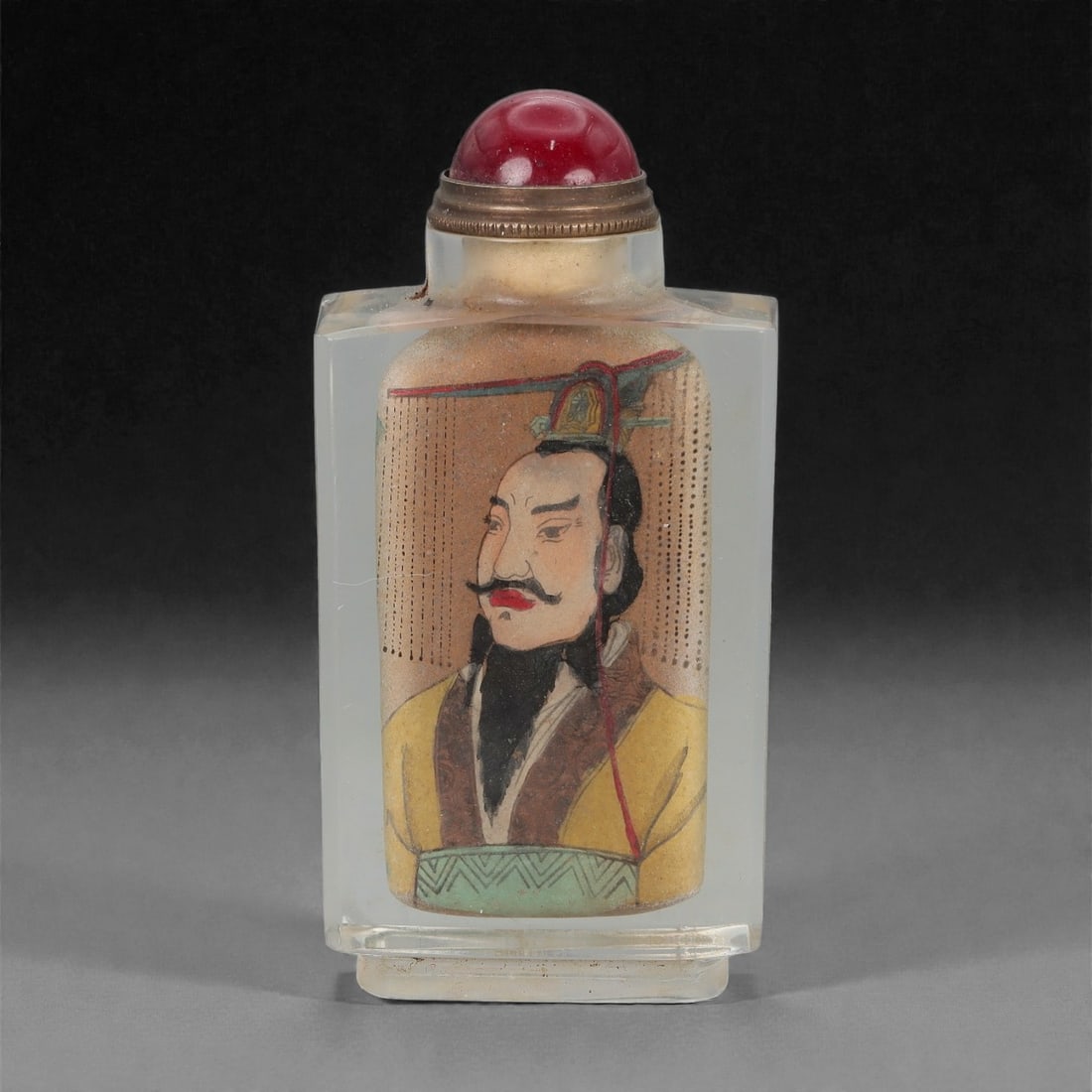 A Chinese Crystal Glass Snuff Bottle, 20th Century, 63FG: The snuff bottle is formed from clear crystal glass and of flattened rectangular form, rising from a narrow foot to a short cylindrical neck with a flat rim. One side is inside-painted with a frontal