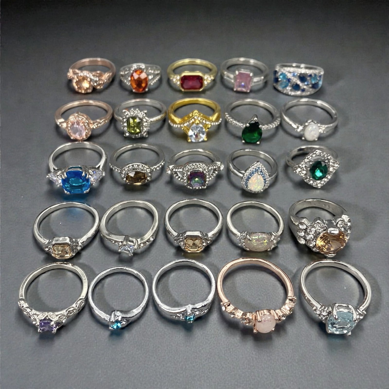 A Group of Modern Metal and Gem-Set Fashion Rings, Late 20th-Early 21st Century, 69XJ: Comprising twenty-five modern fashion rings constructed from mixed base metals and non-precious alloys, the group presents a wide range of contemporary designs set with synthetic, treated, or simulate