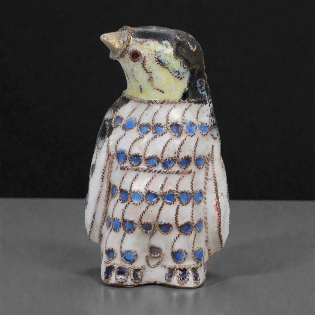 A Chinese Cloisonne Enamel Penguin Effigy, 20th Century, 96FG: Constructed from a copper alloy body and decorated with cloisonne enamel, the object is formed as a standing penguin with an upright posture and the head turned slightly upward. Fine metal wire cloiso