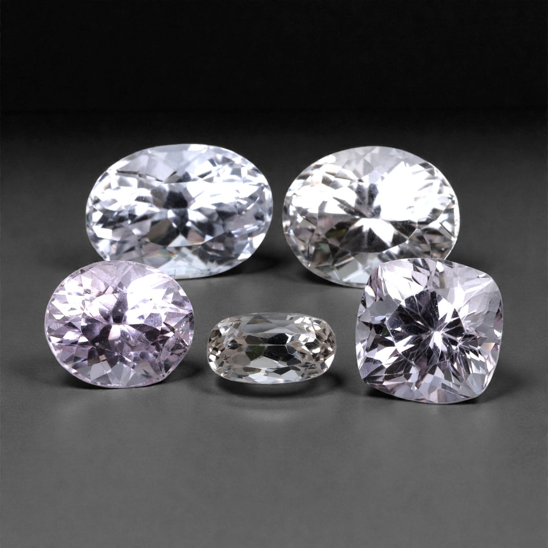 33.02 Carats Pastel Pink Kunzite Selection - Natural Afghan Stones 9-14mm, 68XH: This soft, luminous selection of kunzite gems exudes delicate elegance in shades of pale pink, lilac, and icy rose. Each stone displays impressive brilliance with precision faceting that highlights ku