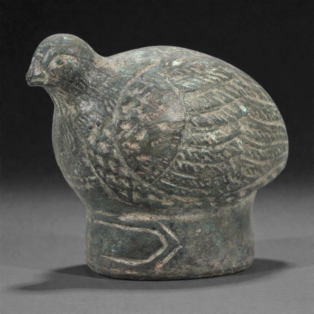A Chinese Bronze Bird-Form Rattle, 20th Century, 19FJ: Cast in bronze, the object is modeled as a compact bird-form figure with a rounded body and a slightly raised head. The surface is worked with incised and low-relief linear detailing suggesting plumag