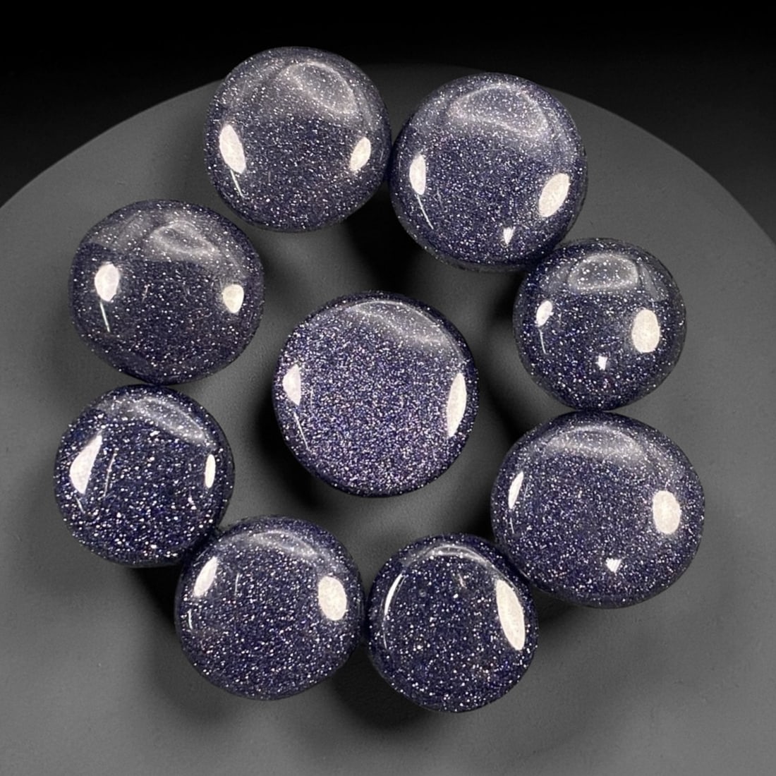 121.13 Carats Midnight Blue Goldstone Round Cabochon Parcel - 1.4-1.8cm, 72ZJ: This striking parcel of midnight blue goldstone round cabochons shimmers with a celestial, star-like sparkle that captures the imagination. Set against a deep, velvety indigo base, each stone is dense