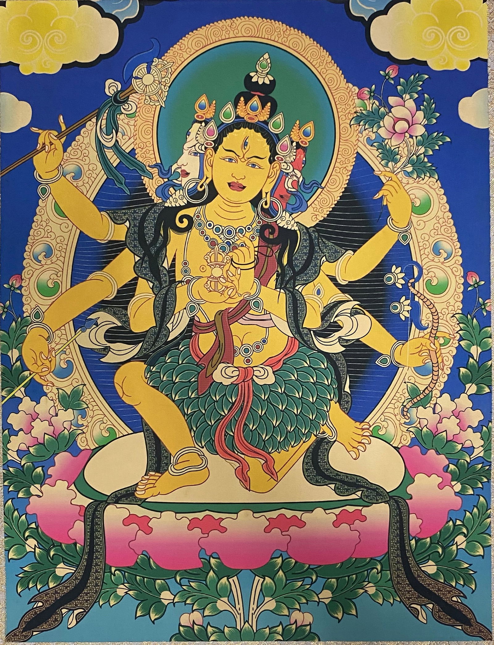 A Chinese Ink and Color Art Print, Multi-Armed Buddhist Deity Thangka, 20th Century, 16FV: Printed on a vivid indigo ground, the composition depicts a multi-armed Buddhist deity rendered in the traditional Tibetan thangka iconographic style. The figure features a golden-hued body with a thi