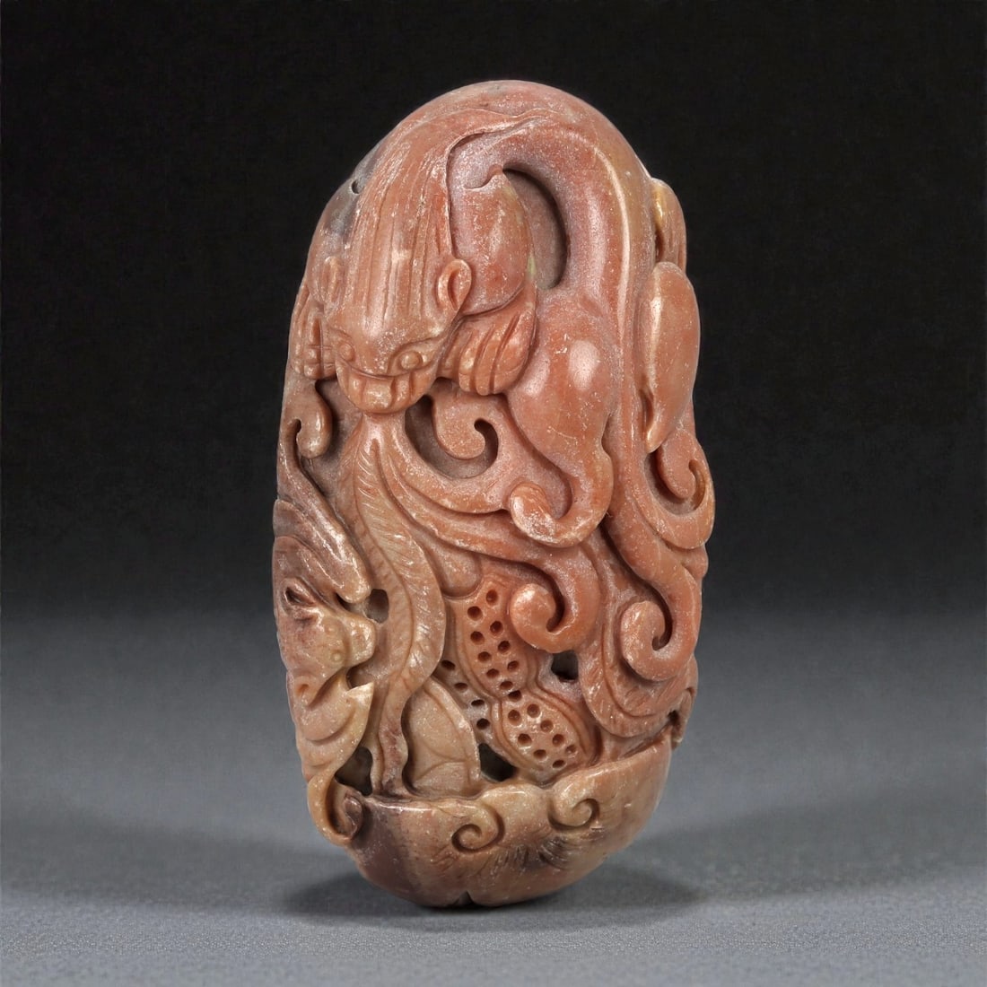 A Chinese Hardstone Carving of a Mythical Beast, 20th Century, 13FD: Carved from a dense hardstone of warm russet-brown tone with lighter inclusions, the sculpture is worked in the round as a stylized mythical beast, possibly a qilin or related zoomorphic creature. The