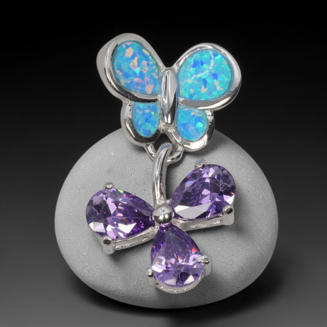 3.47g 925 Sterling Silver Butterfly Pendant - Simulated Opal Amethyst, 19D: Crafted from stamped 925 sterling silver, this pendant features a dual-butterfly design with polished openwork detailing. The upper butterfly is inlaid with four segments of simulated opal, displaying