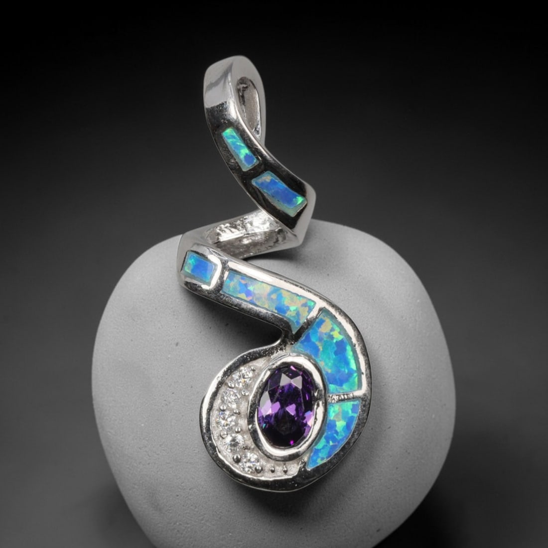 4.02g 925 Sterling Silver Swirl Pendant - Simulated Opal Amethyst, 31D: Crafted from stamped 925 sterling silver, this pendant features a dynamic swirling openwork design. Irregular segments of simulated opal are inlaid along the curved silver bands, exhibiting vivid irid