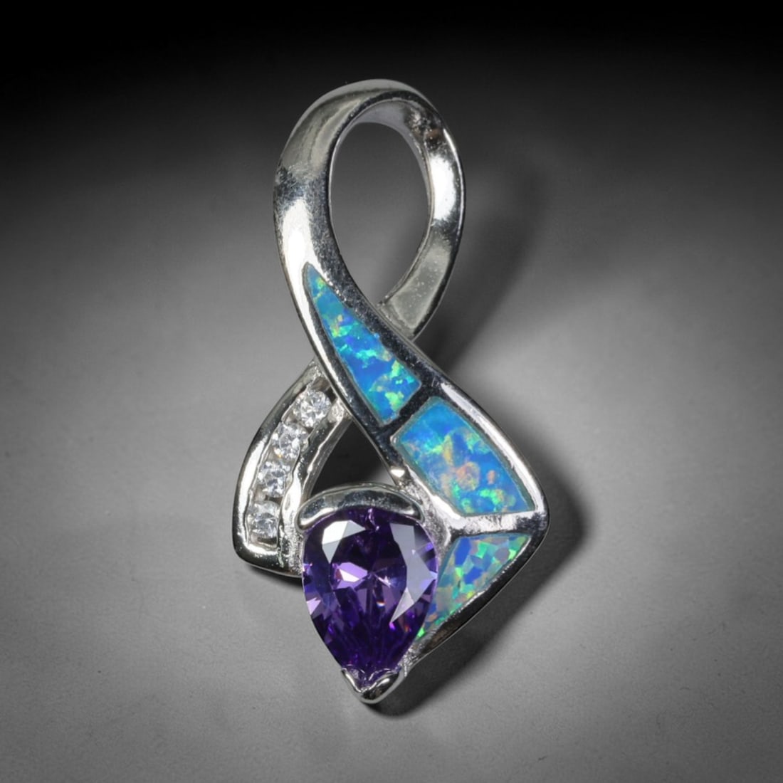 4.23g 925 Sterling Silver Infinity Pendant - Simulated Opal Amethyst, 24D: Crafted from stamped 925 sterling silver, this pendant features a flowing infinity symbol design with polished openwork detailing. Three irregular segments of simulated opal are inlaid along one curve