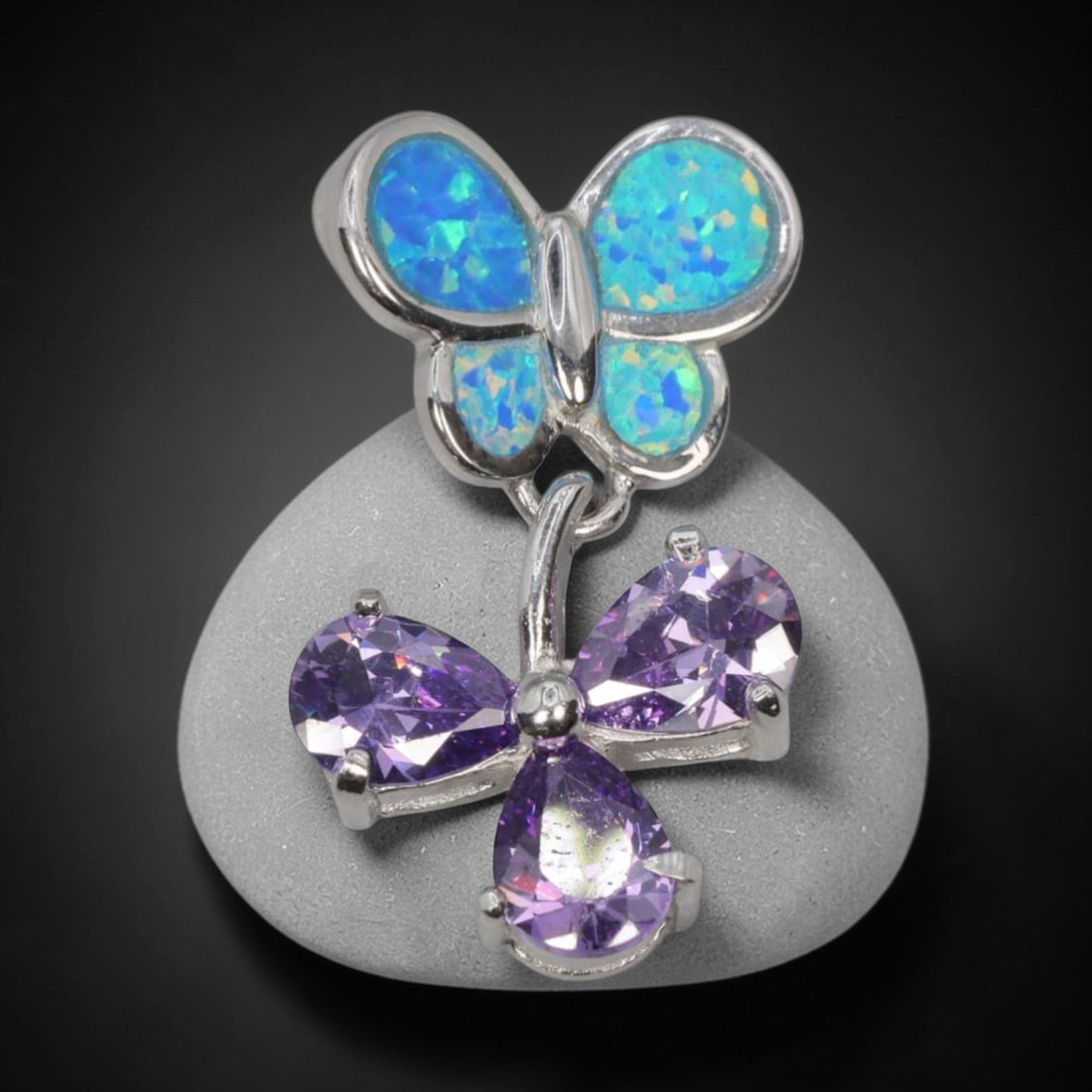 3.36g 925 Sterling Silver Butterfly Pendant - Simulated Opal Amethyst, 46D: Crafted from stamped 925 sterling silver, this pendant features a dual-butterfly design with polished openwork detailing. The upper butterfly is inlaid with four segments of simulated opal, displaying