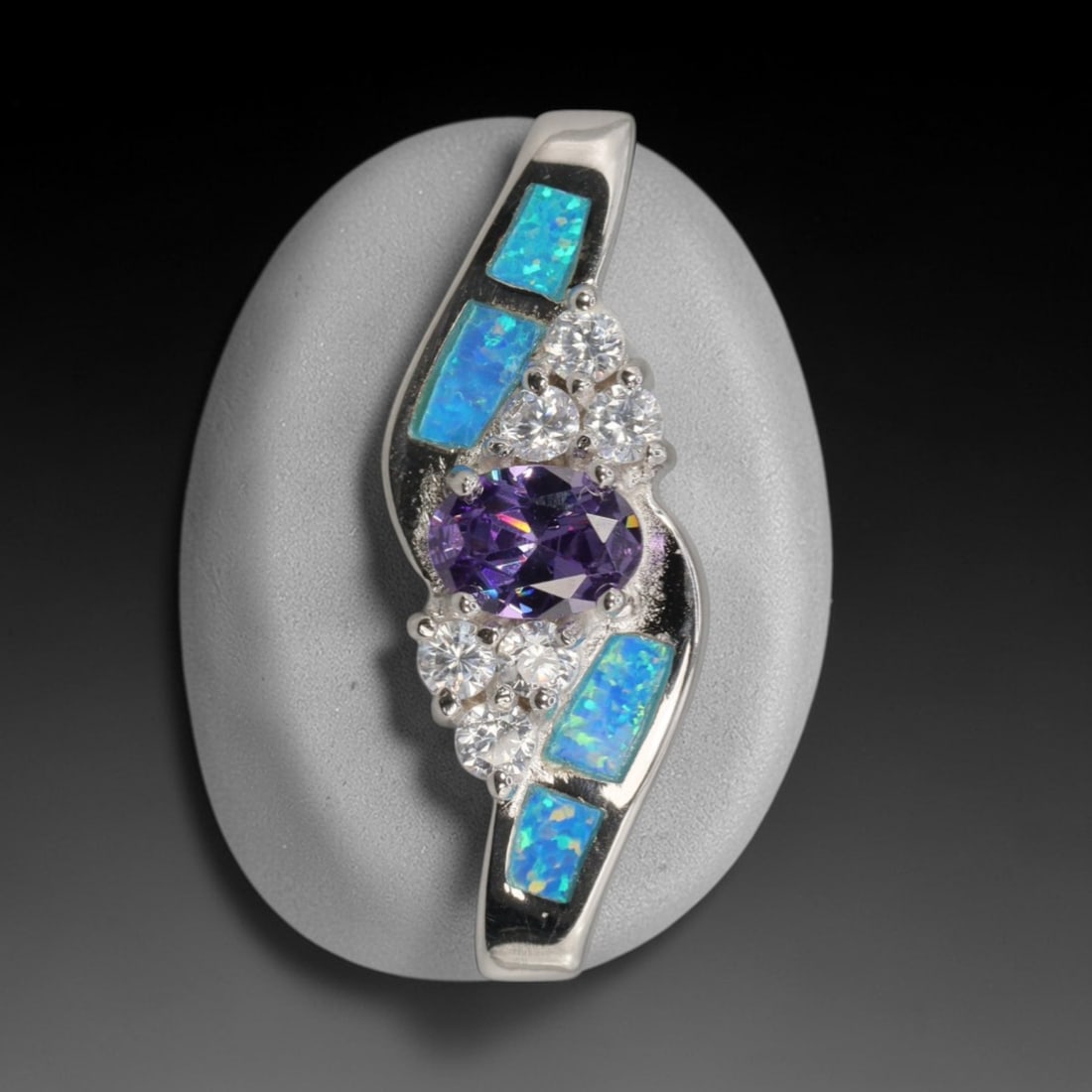 3.89g 925 Sterling Silver Drop Pendant - Simulated Opal Amethyst, 15D: Crafted from stamped 925 sterling silver, this pendant features a curved openwork upper section with three rectangular segments of simulated opal inlay, exhibiting vivid iridescent green and blue play