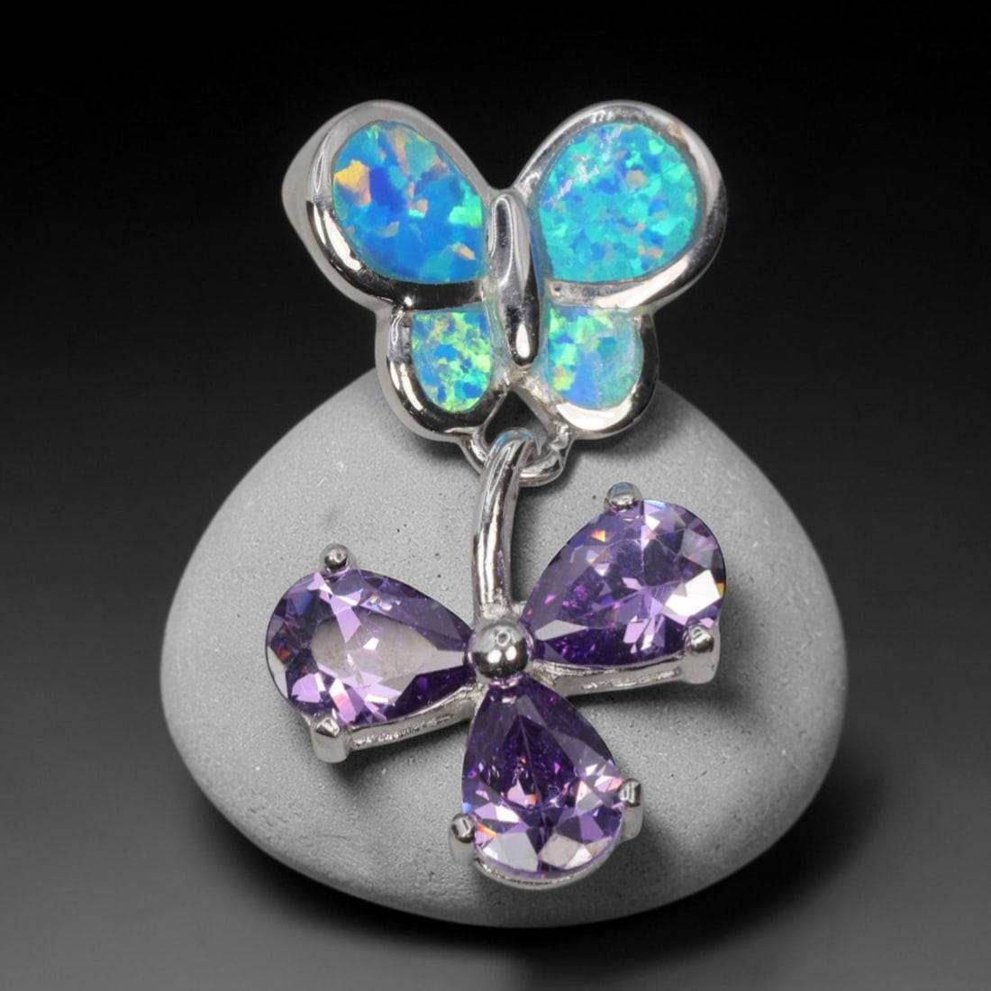 3.41g 925 Sterling Silver Butterfly Pendant - Simulated Opal Amethyst, 10D: Crafted from stamped 925 sterling silver, this pendant features a dual-butterfly design with polished openwork detailing. The upper butterfly is inlaid with four segments of simulated opal, displaying