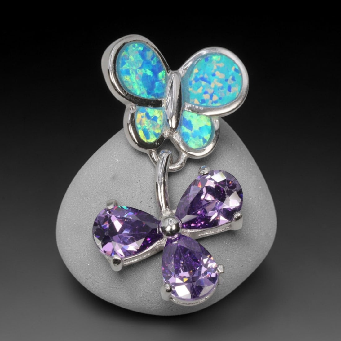 2.5g 925 Sterling Silver Butterfly Pendant - Simulated Opal Amethyst, 39D: Crafted from stamped 925 sterling silver, this pendant features a dual-butterfly design with polished openwork detailing. The upper butterfly is inlaid with four segments of simulated opal, displaying