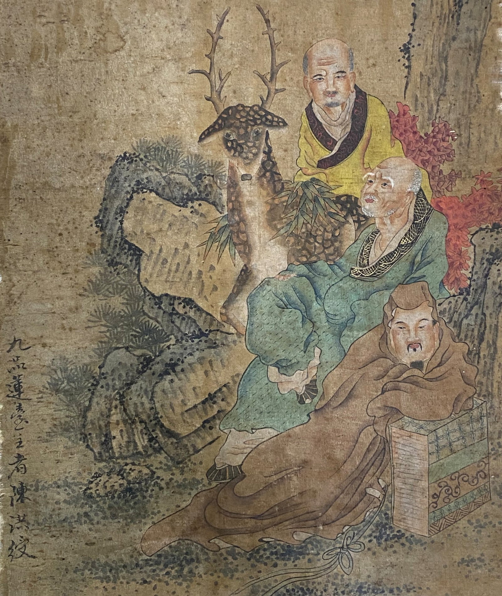 A Chinese Ink and Color Art Print, Scholars with a Deer, 20th Century, 21FV: Printed on an aged, textured fabric or linen ground, the composition depicts three figures in a landscape setting. Two scholars in flowing robes of green and brown are seated in the foreground, while