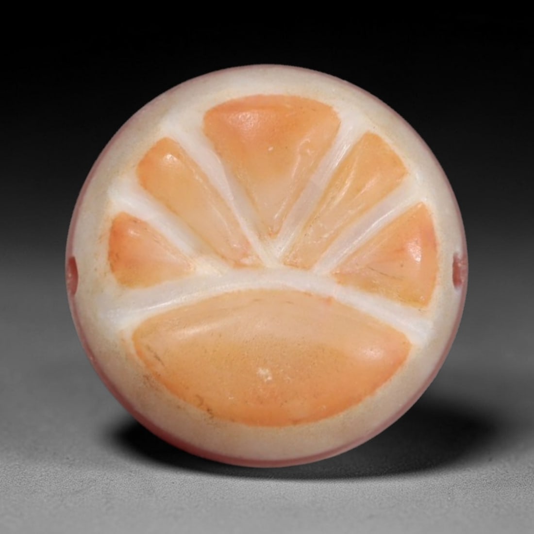 Antique Agate Citrus Slice Bead - Central Asian Gemstone Pendant, 6AR: Carved from banded agate with a creamy white base and warm orange inclusions, this bead features a symmetrical citrus slice motif with five distinct wedge segments and a lower half-slice, separated by