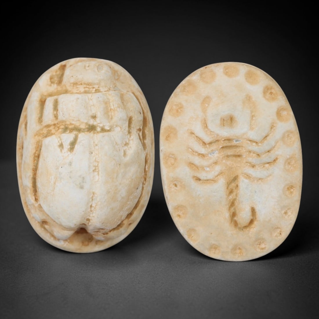 An Ancient Near Eastern Stone Scarab Stamp Seal with Scorpion Motif, 1st Millennium BCE, 96AC: Carved from pale, weathered stone with minor natural inclusions and subtle surface discoloration, the object is formed as an oval scarab seal. The dorsal side is modeled in low relief with a segmented
