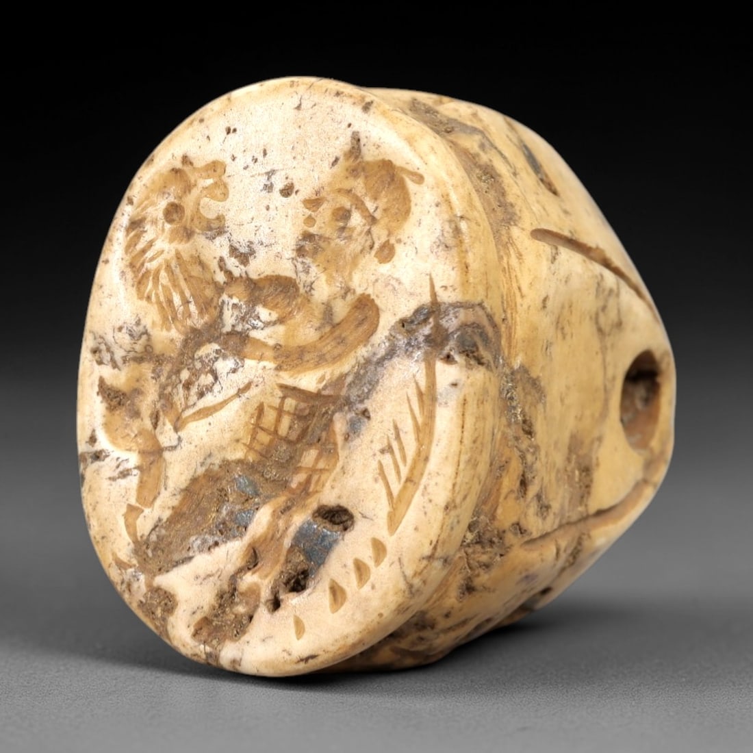Ancient Bone Stamp Seal - Mythological Figure & Griffin Talisman, 92AL: This stamp seal is carved from pale, aged bone with natural veining and a weathered patina, featuring a detailed incised scene of a human figure confronting a griffin (mythical winged beast) within a