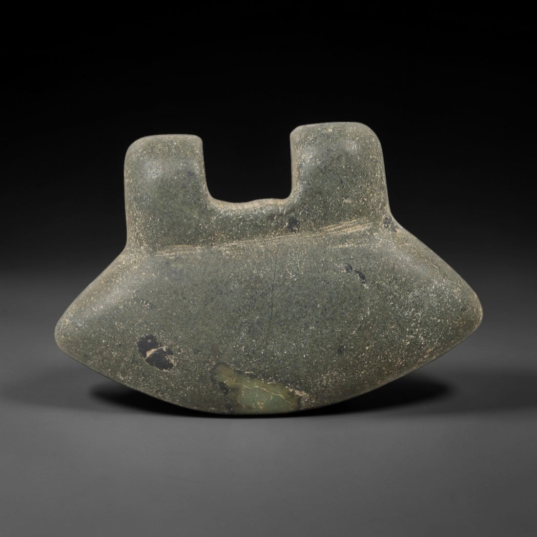 Ancient Stone Eye Idol - Near Eastern Ritual Figurine, 40AG: This amulet is carved from a single piece of mottled green stone, exhibiting a granular texture with subtle mineral veining and a uniform matte patina across its surface. The form is a stylized eye id