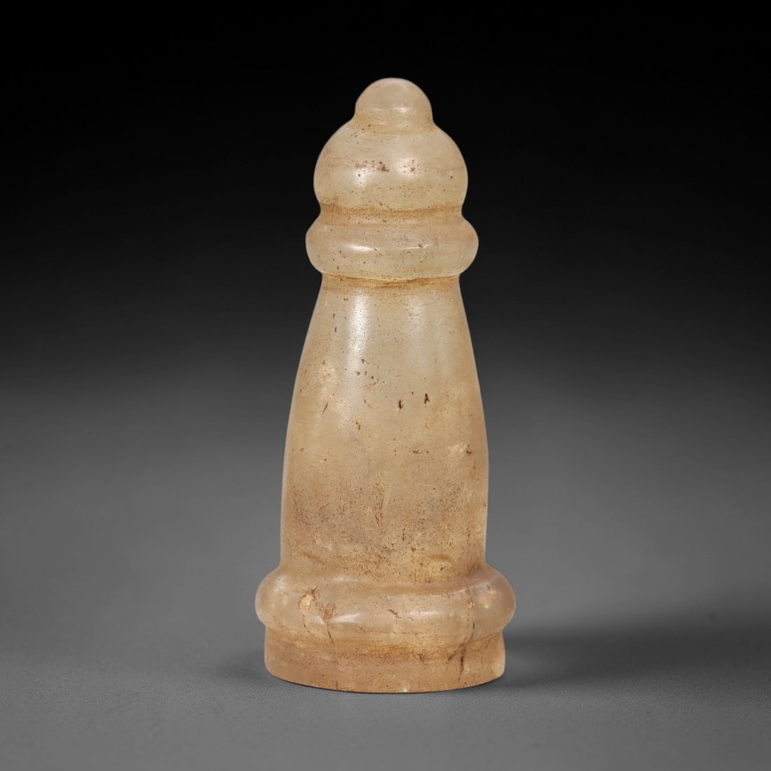 Ancient Rock Crystal Chess Piece - Medieval or Islamic Period Game Artifact, 96AL: This elegant chess piece is carved from translucent pale rock crystal, featuring a tiered, columnar form with a domed finial and a flared base. The piece reflects the sophisticated lapidary traditions
