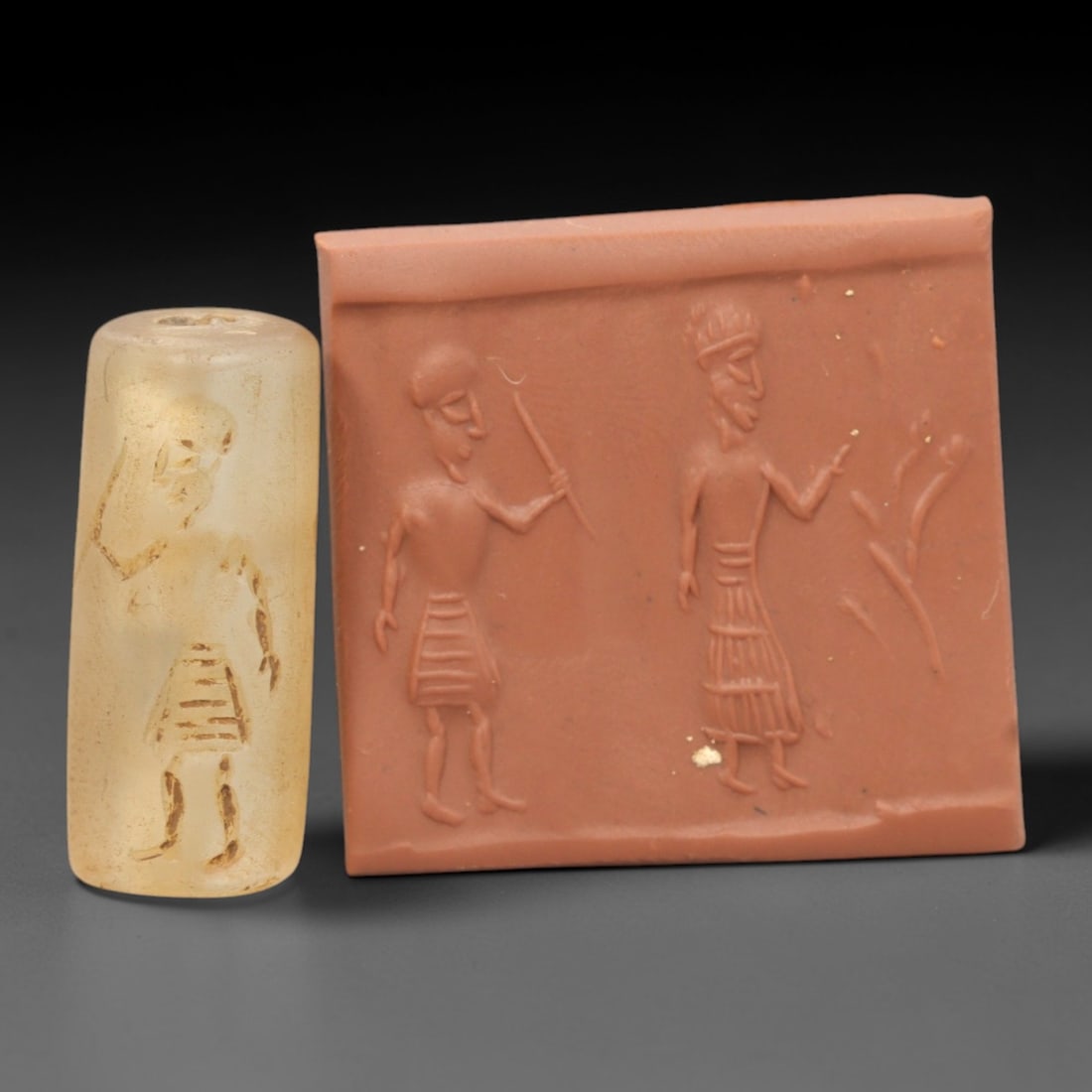 Ancient Rock Crystal Cylinder Seal - Near Eastern Figural Scene, 89ZR: Carved from translucent pale rock crystal with a naturally frosted, weathered patina, executed in a cylindrical form characteristic of Near Eastern cylinder seal craftsmanship. The seal's surface bear