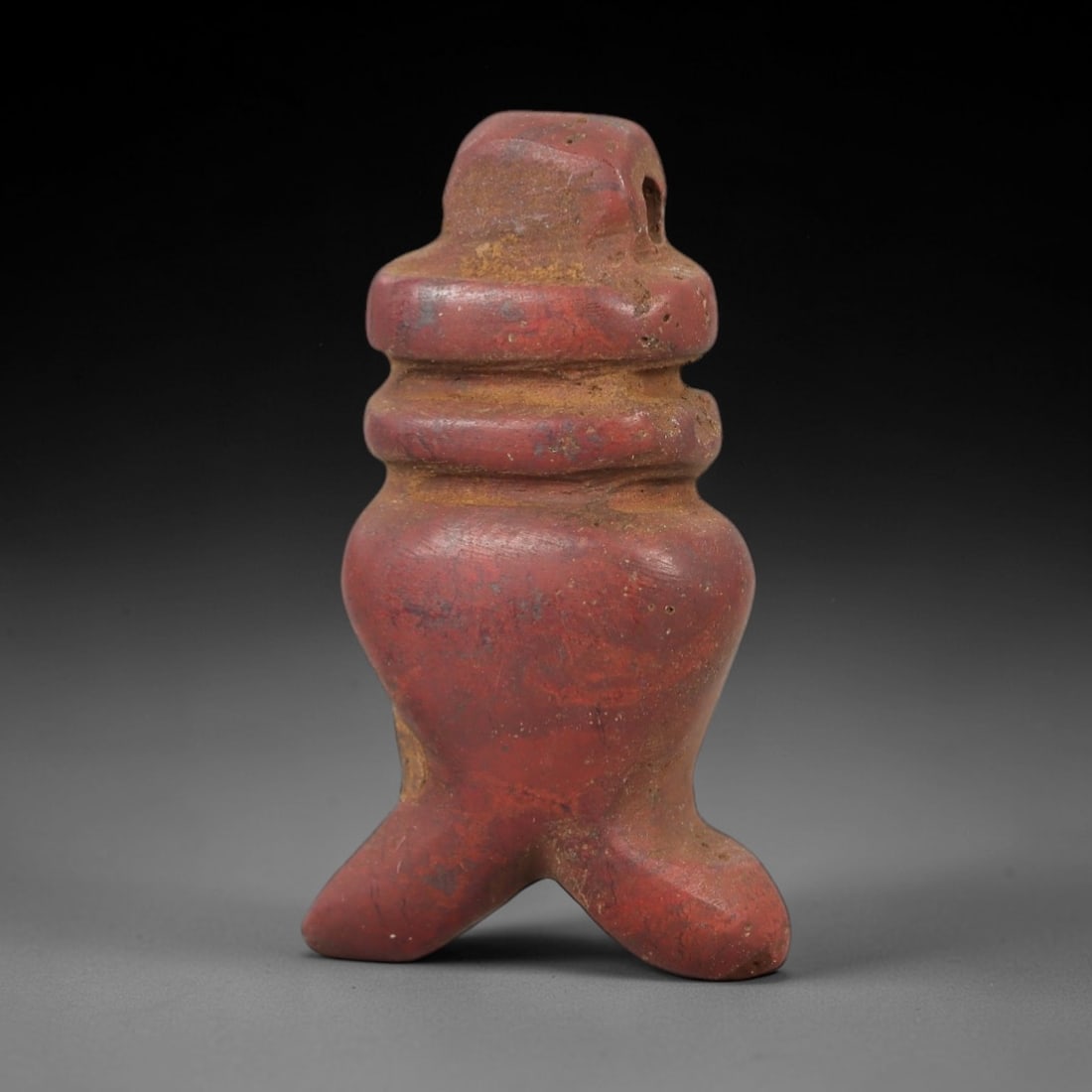 Ancient Red Stone Pendant - Egyptian Style Figurine, 58AE: Carved from red stone, this ancient Egyptian-style pendant features a compact, stylized form with defined body details and a suspension hole at the top, indicating its use as a wearable amulet. The ca