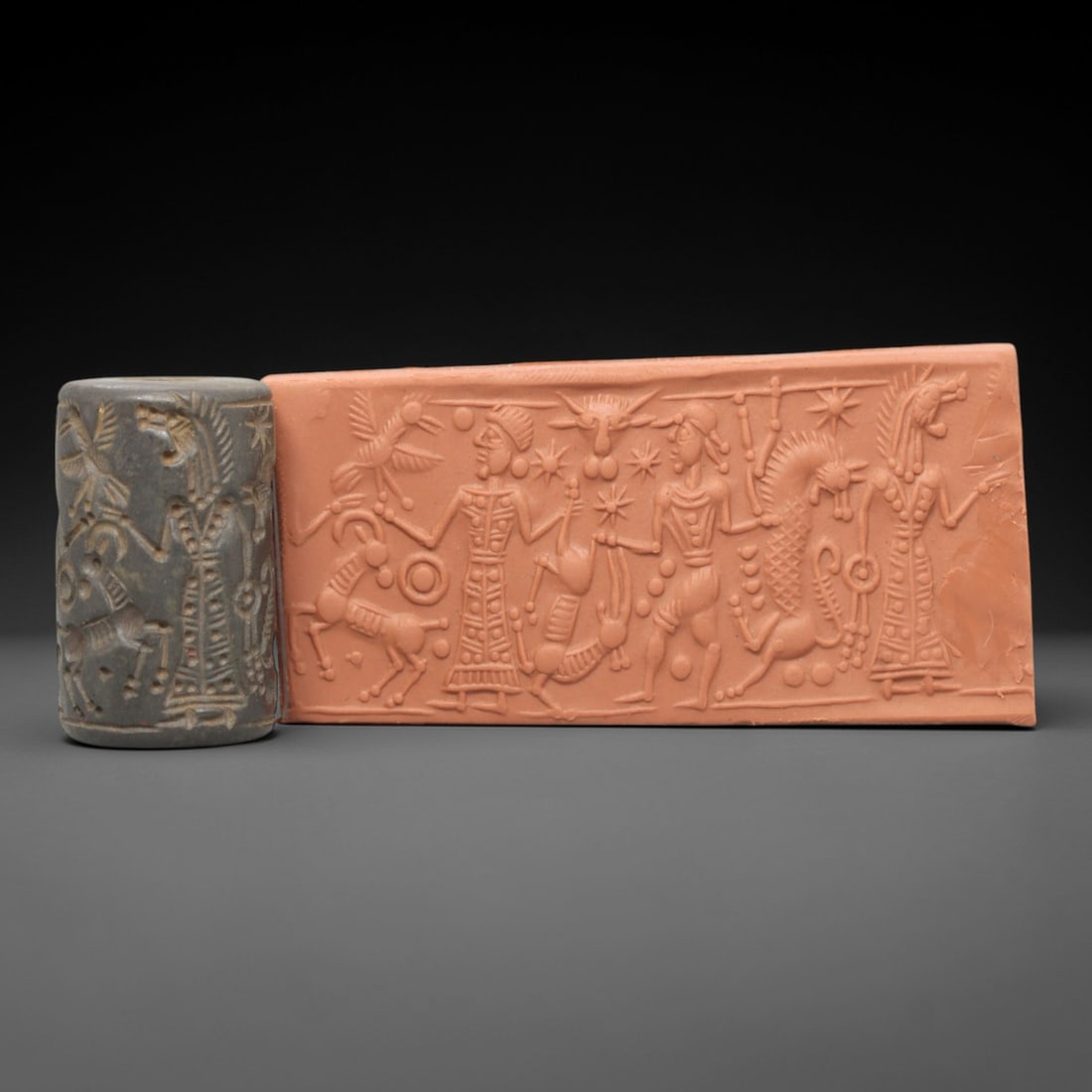 Ancient Steatite Cylinder Seal - Mesopotamian Mythological Procession Scene, 36AL: Carved from dark, finely grained steatite, this ancient Mesopotamian cylinder seal depicts a complex mythological procession scene, executed with meticulous glyptic craftsmanship characteristic of the