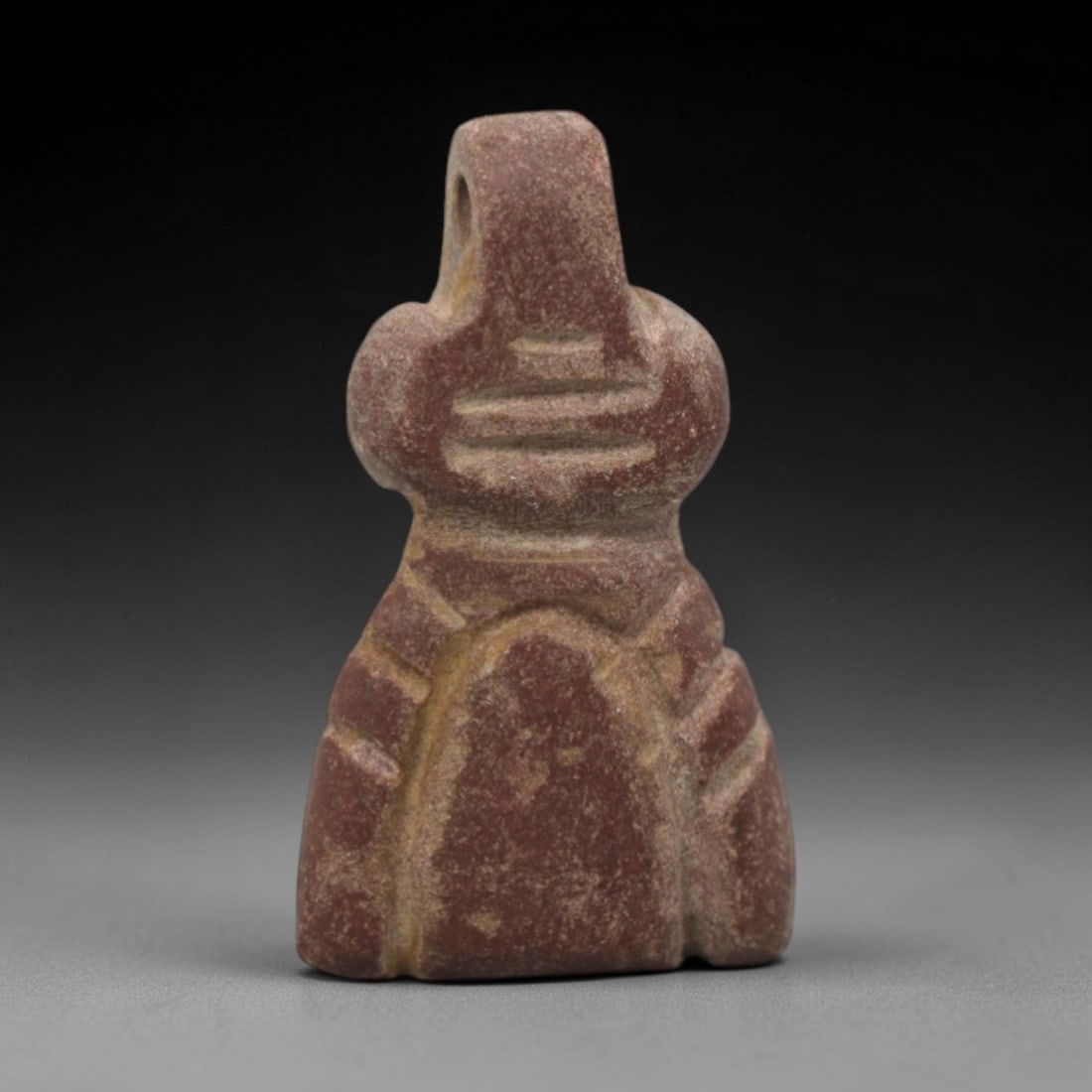 Ancient Egyptian Red Stone Tyet (Isis Knot) Amulet - Carved Pendant Figure, 3ZV: This amulet is carved from a rich, deep red stone with natural mineral speckling and patination, likely brecciated jasper or red steatite, featuring the iconic tyet (Isis knot) form. The piece display