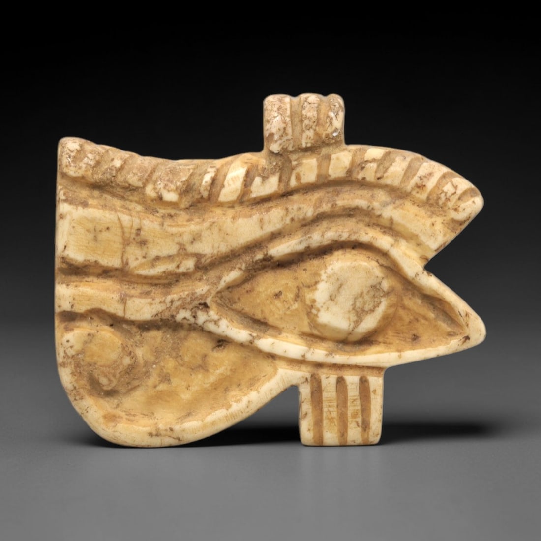 Ancient Stone Wedjet Eye Amulet - Egyptian Protective Figurine, 13ZR: This artifact is a carved stone Wedjet Eye amulet, executed in the iconic protective tradition of ancient Egypt. The amulet depicts the Wedjet (Eye of Horus) with distinct contours defining the eye so