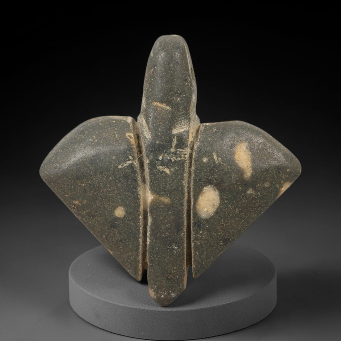 Ancient Grey Stone Amulet - Egyptian Style Figurine, 70AE: Carved from grey stone, this ancient Egyptian-style amulet features a compact, triangular form with incised linear details and a suspension hole at the top, indicating its use as a wearable amulet. Th
