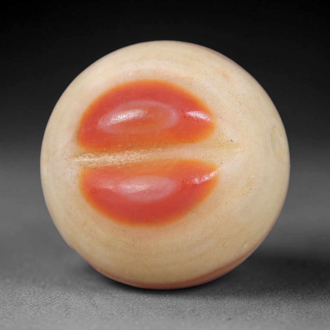 Antique Agate Eye Bead - Central Asian Gemstone Pendant, 9AR: Carved from banded agate with creamy white base tones and striking concentric orange-red eye-like inclusions, this bead features a smooth spherical form with a central perforation for wearability. The