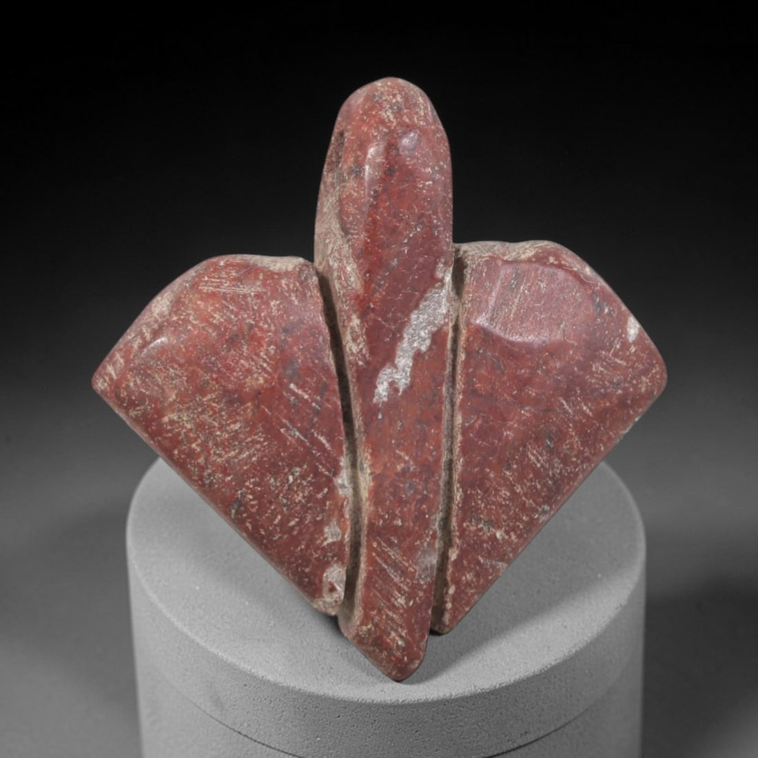 Ancient Stone Amulet - Egyptian Ritual Pendant, 47AP: This artifact is carved from variegated red stone with a heavily weathered, matte patina and prominent mineral veining, exhibiting a highly stylized, abstract form consistent with ancient Egyptian sto