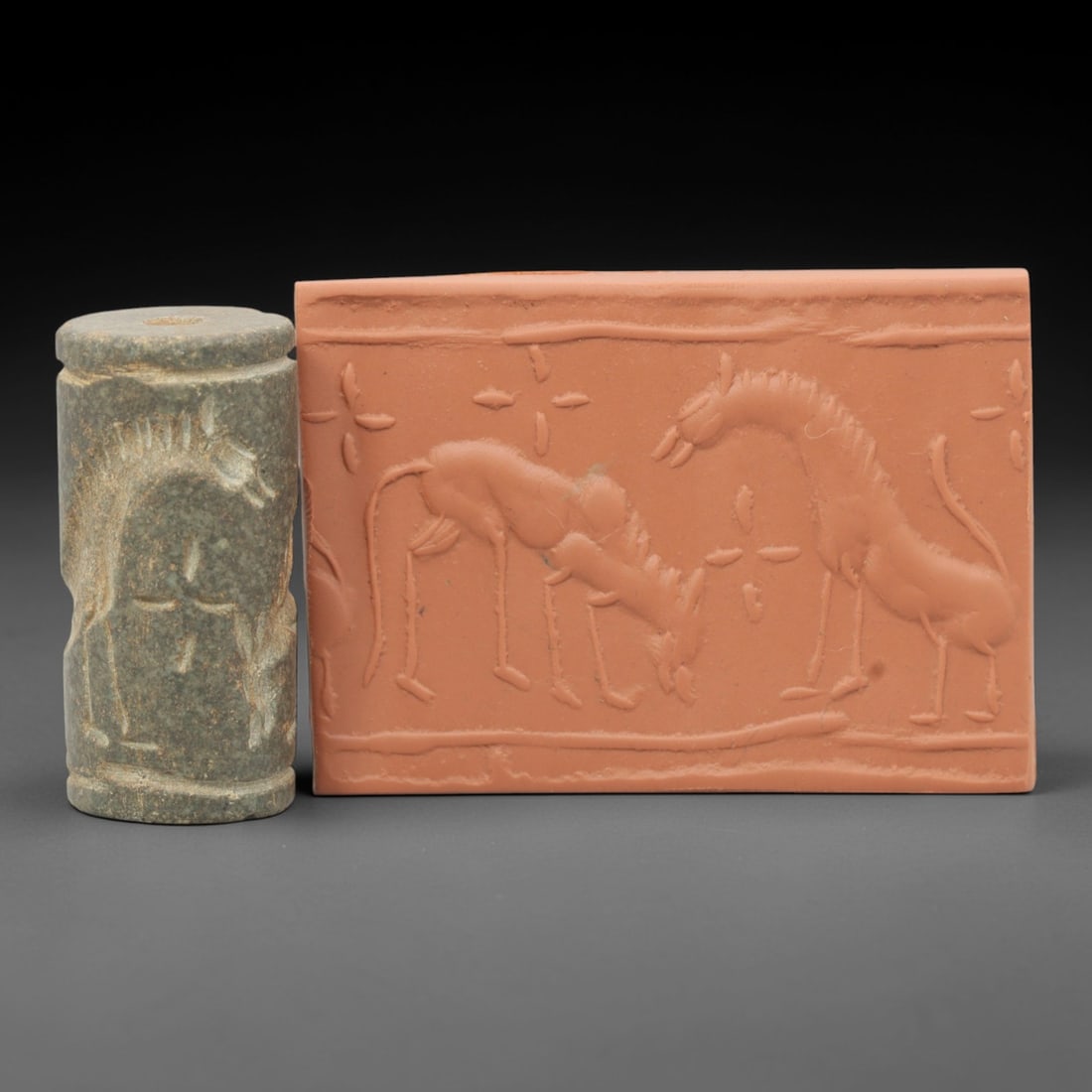 Ancient Steatite Cylinder Seal - Near Eastern Glyptic Art, 81ZQ: Carved from steatite stone, this ancient Near Eastern cylinder seal features a cylindrical form with raised relief carvings depicting stylized equine figures with detailed linear patterns and geometri