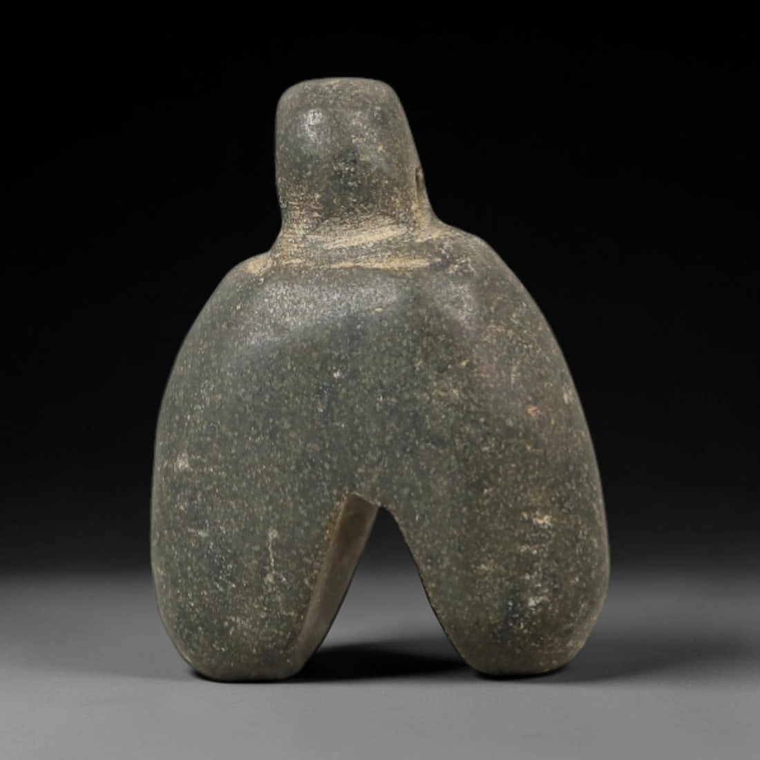 Ancient Stone Fly Amulet - Near Eastern Ritual Figurine, 71AG: This amulet is carved from a single piece of dark grey-green stone, exhibiting a granular texture with subtle lighter mineral flecks and a uniform matte patina across its surface. The form is stylized