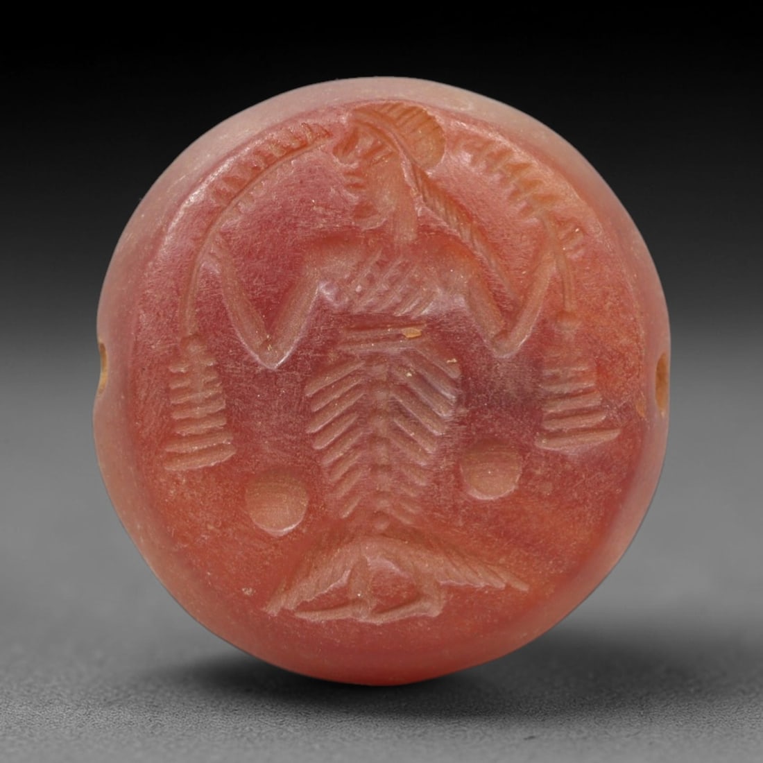 Ancient Carnelian Intaglio - Near Eastern Figurine Amulet, 18XV: Carved from carnelian, this intaglio amulet takes a circular form, featuring a finely rendered anthropomorphic figure in profile with outstretched arms, detailed incised striations defining the torso