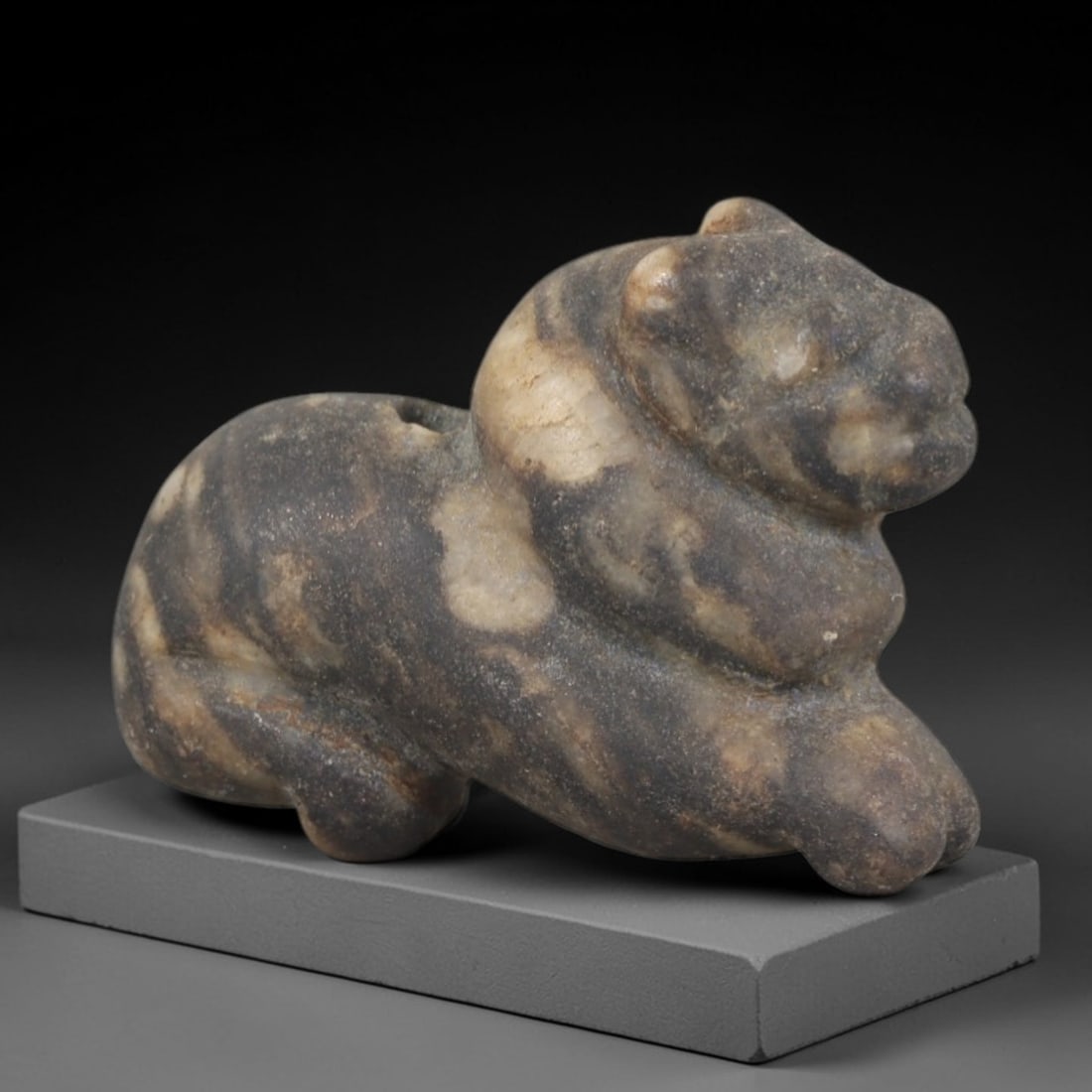 Ancient Stone Lion - Egyptian Amulet Figurine, 58AP: This artifact is carved from banded gray stone with a weathered, earthy patina and natural mineral veining, exhibiting stylized feline features consistent with ancient Egyptian stoneworking techniques