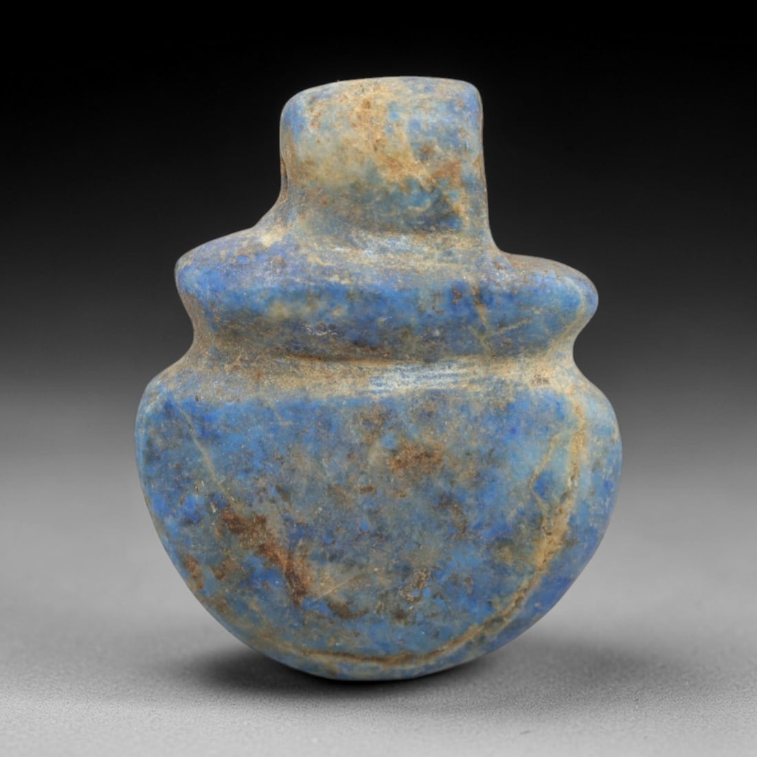 Ancient Lapis Lazuli Heart Amulet - Egyptian Ritual Pendant, 36ZT: Carved from lapis lazuli, this amulet features a rounded heart form with a cylindrical upper lug pierced for suspension, its body defined by a subtle raised collar at the shoulder. The deep blue stone