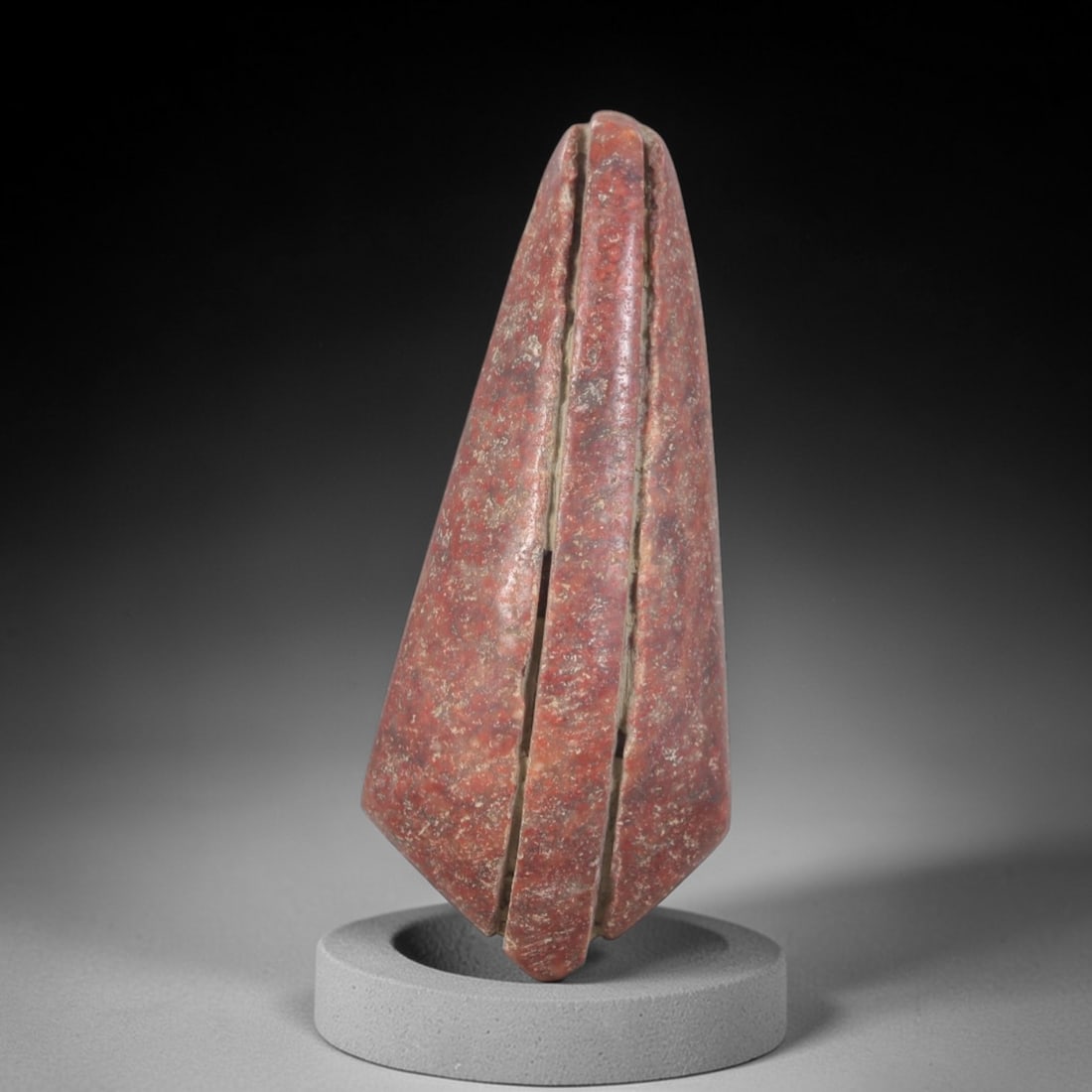 Ancient Red Stone Cone Amulet - Near Eastern Ritual Object, 53AP: Carved from a dense, reddish-brown stone, possibly serpentine or ferruginous quartzite, this conical amulet features a pronounced vertical slit running along its apex, creating a distinctive bifurcate