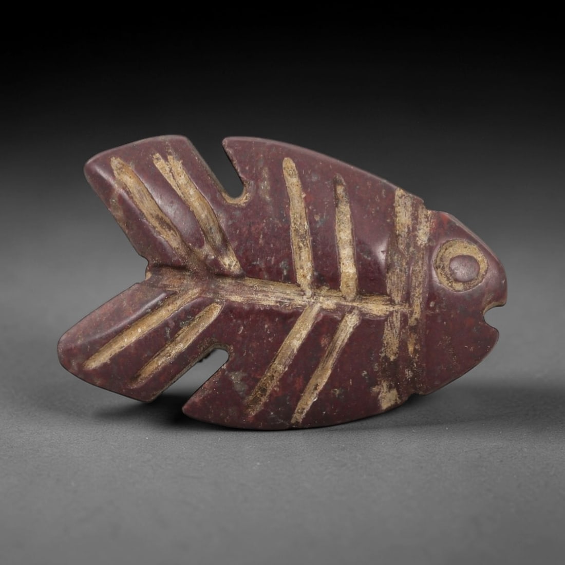 Ancient Egyptian Stone Fish Amulet - Nile Tilapia Carving, 24AG: Carved from stone, this ancient Egyptian fish amulet depicts a Nile tilapia, a sacred species associated with fertility and rebirth in ancient Egyptian belief. The stylized carving features incised de