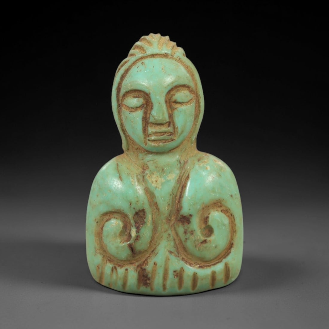 Ancient Turquoise Anthropomorphic Amulet - Near Eastern Figurine, 82AK: Crafted from polished turquoise, this amulet depicts a stylized anthropomorphic bust with closed eyes, a simplified facial structure, and incised linear details defining the hair and lower torso. The