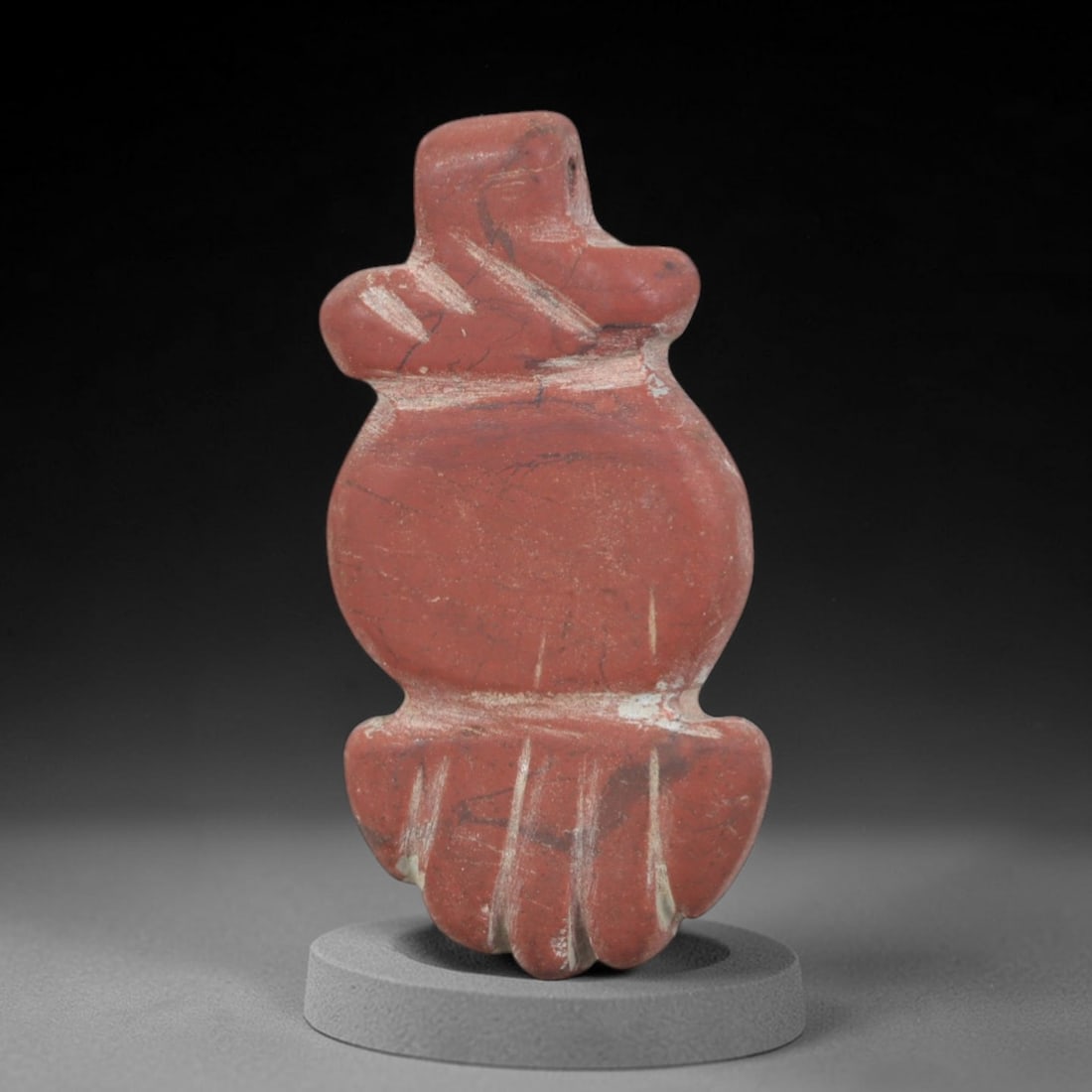 Ancient Jasper Bird Amulet - Near Eastern Figurine, 68AP: This artifact is carved from rich red jasper, displaying natural veining and subtle mineral variations across its surface. The form is a stylized avian amulet, with a rounded head, simplified upper bo