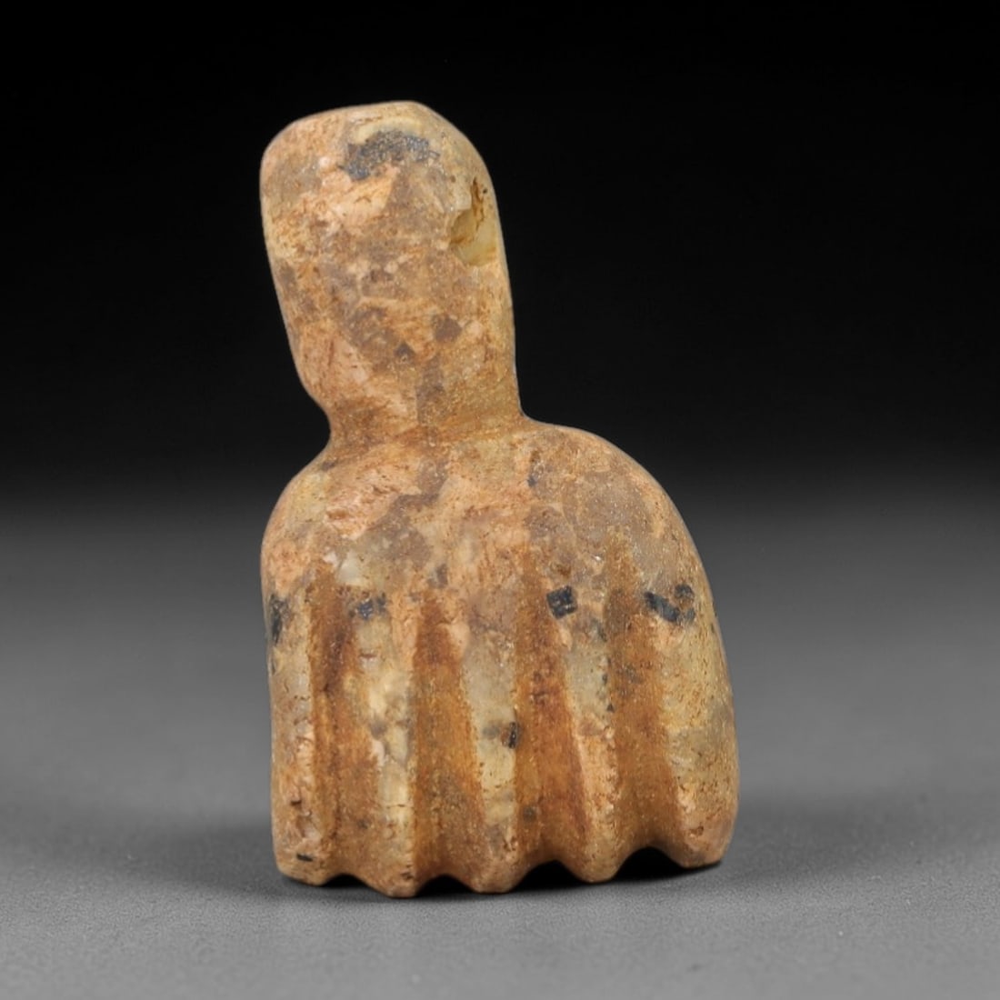 Ancient Stone Fist Amulet - Near Eastern Figurine, 72AG: This artifact is a carved stone fist amulet of Near Eastern origin, fashioned from a warm, ochre-toned stone with natural mineral inclusions and dark surface markings. Its form depicts a stylized clen