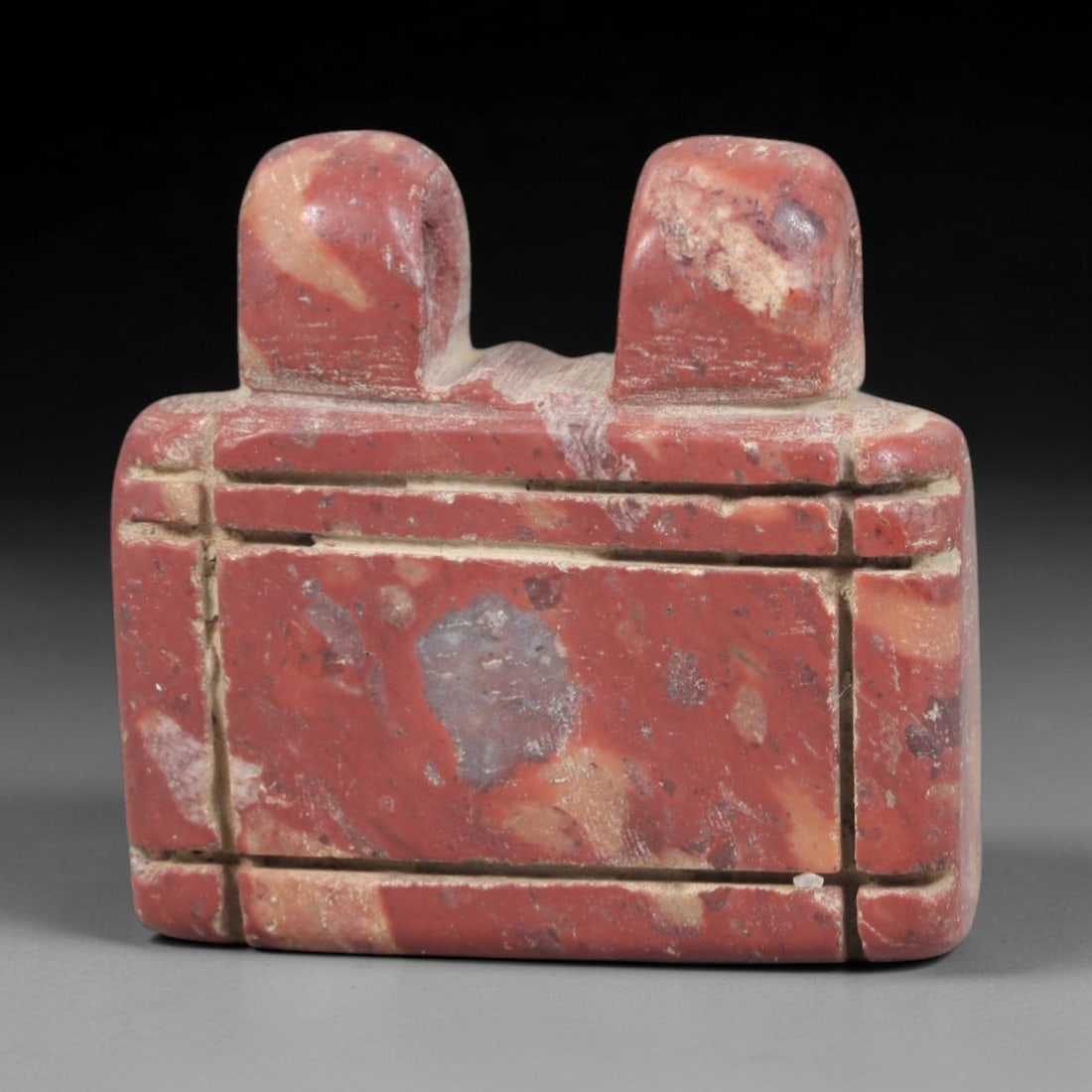 Ancient Stone Amulet - Egyptian Ritual Pendant, 66AP: This artifact is carved from variegated red stone with natural mineral inclusions and a weathered patina, exhibiting precise incised linear detailing consistent with ancient Egyptian stoneworking tech