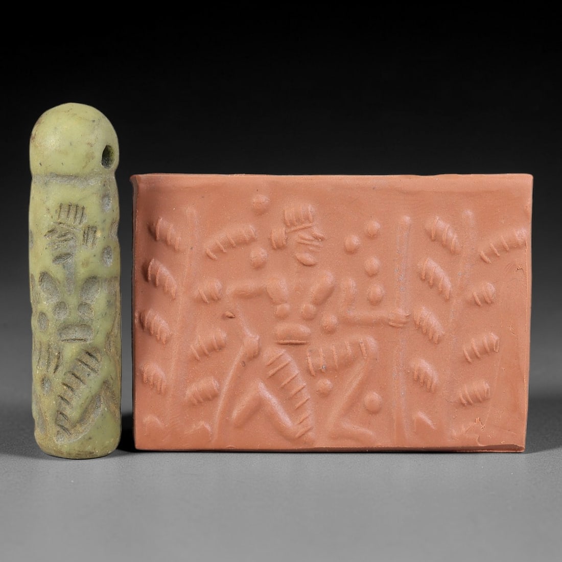 Ancient Serpentine Cylinder Seal - Mesopotamian Figural Tree Motif, 67FX: Carved from serpentine, this cylinder seal follows the classic cylindrical form of ancient Mesopotamian administrative and ritual artifacts. Its surface bears a detailed figural scene, featuring a cen