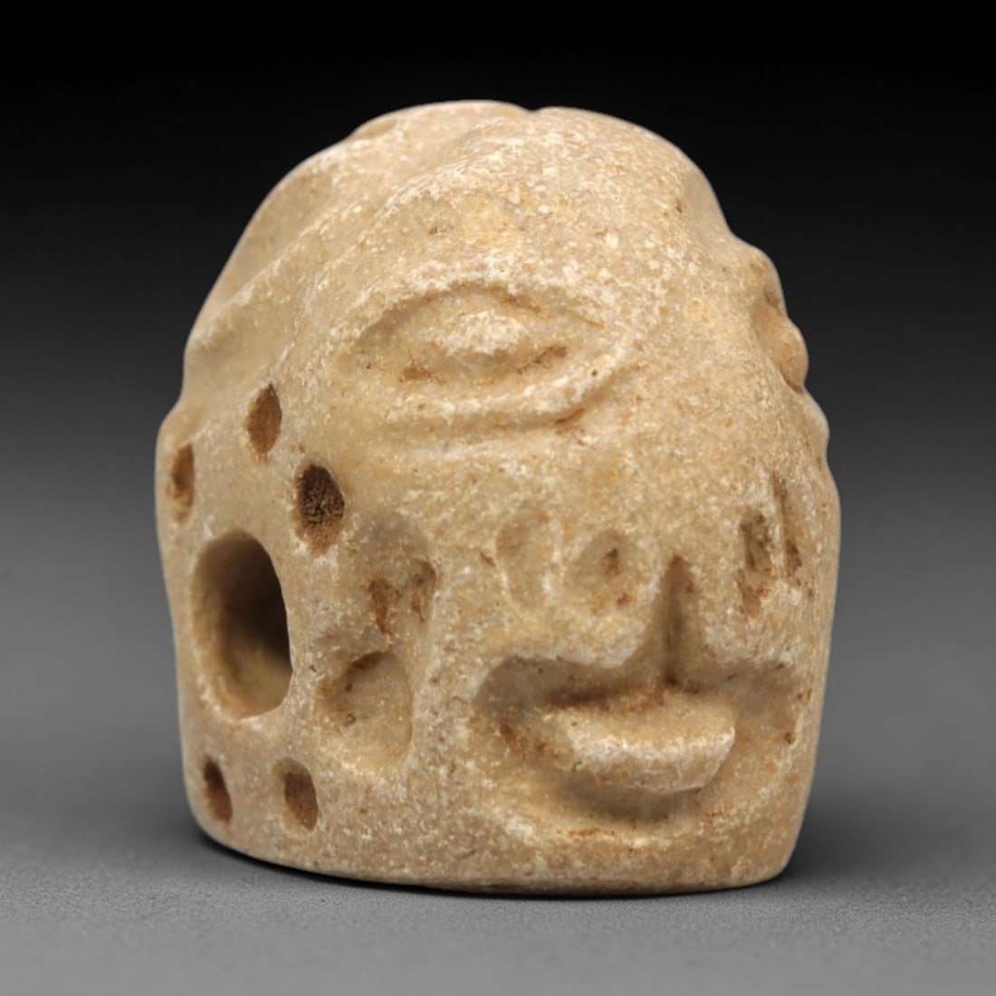 Ancient Limestone Humanoid Stamp Seal - Near Eastern Amulet, 100ZR: This artifact is a carved limestone stamp seal of humanoid form, exhibiting the compact, stylized craftsmanship characteristic of ancient Near Eastern glyptic art. The surface features incised iconogr
