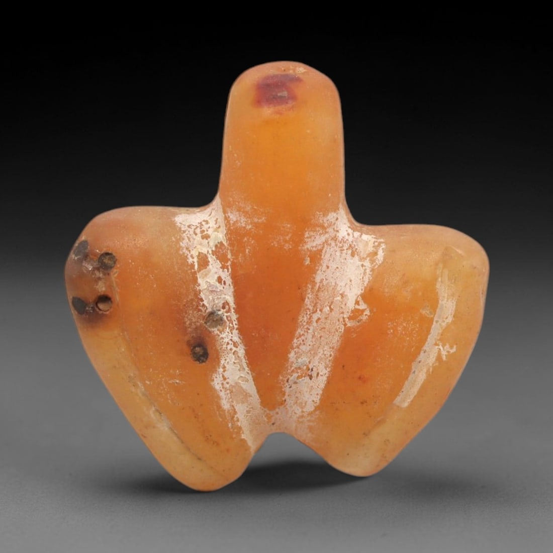 Ancient Carnelian Bird Amulet - Egyptian Figurine, 88XS: Carved from warm, translucent orange-red carnelian with natural tonal gradients and subtle surface patination, this amulet is formed as a stylized bird with incised linear detailing to define wing con