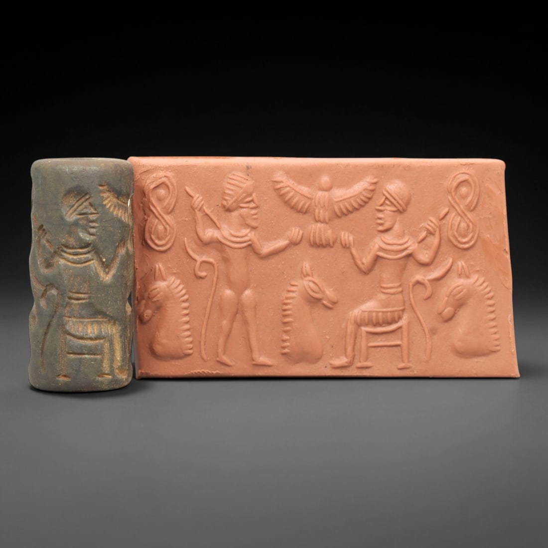 Ancient Steatite Cylinder Seal - Mesopotamian Royal Audience Scene, 50AL: Carved from dark, weathered steatite, this ancient Mesopotamian cylinder seal depicts a formal royal audience scene, executed with precise glyptic craftsmanship characteristic of the Neo-Assyrian peri