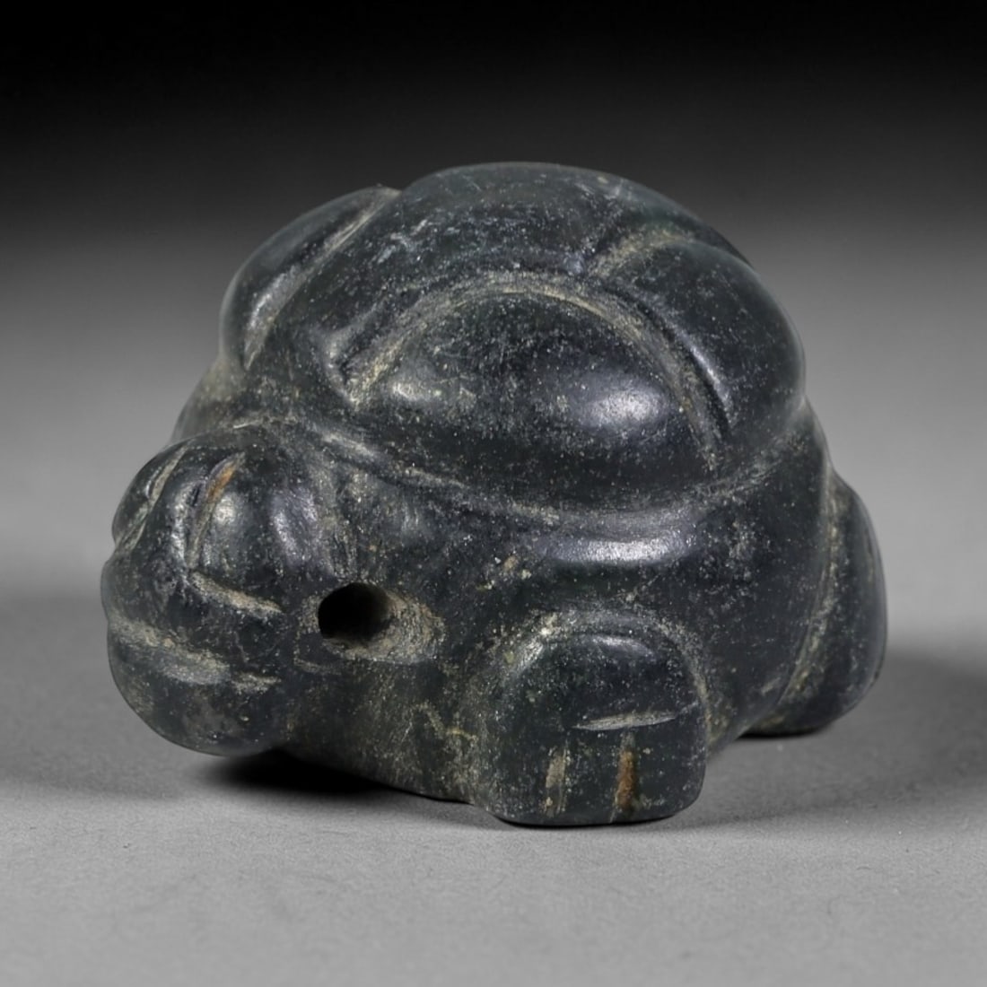 Ancient Serpentine Tortoise Amulet - Near Eastern Figurine, 42AP: This artifact is carved from deep green serpentine, exhibiting a smooth, polished surface with natural mineral speckling and faint surface wear consistent with age. The form is a compact, stylized tor
