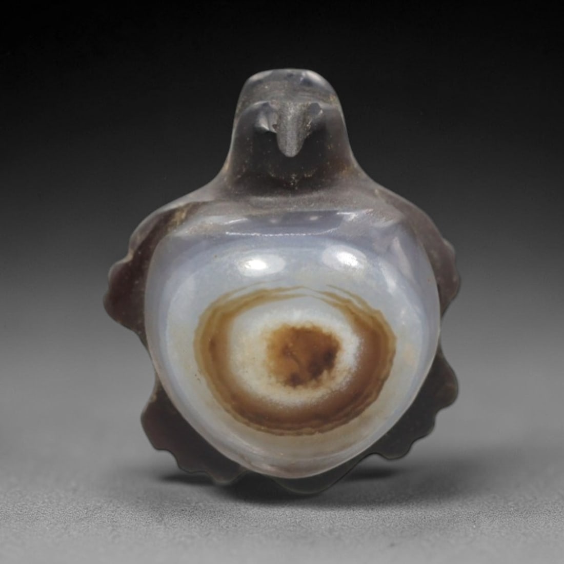 Antique Agate Tortoise Amulet - Central Asian Eye-Bead Talisman, 15ZW: Carved from banded agate with a striking natural "eye" formation at its center, this amulet takes the form of a stylized tortoise with a domed, translucent shell and simplified facial features. The co