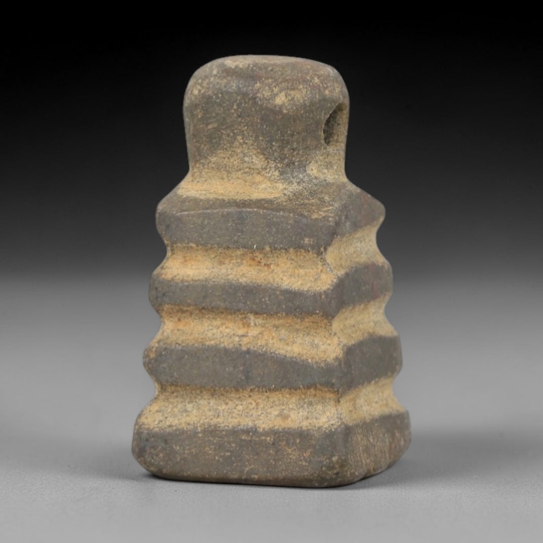Ancient Stone Djed Amulet - Egyptian Ritual Pendant, 50AR: Carved from dense, weathered stone, this djed amulet follows the canonical form of the Egyptian symbol of stability and Osirian resurrection. The piece features stacked horizontal ridges representing