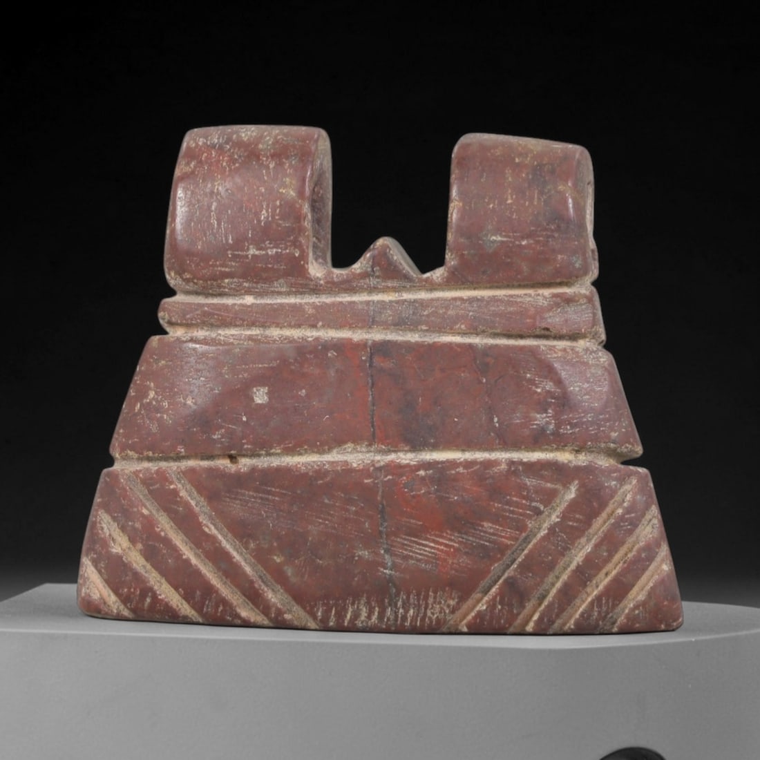 Ancient Stone Amulet - Egyptian Ritual Pendant, 67AP: This artifact is carved from deep red stone with a heavily weathered, matte patina and natural mineral veining, exhibiting tiered geometric detailing consistent with ancient Egyptian stoneworking tech