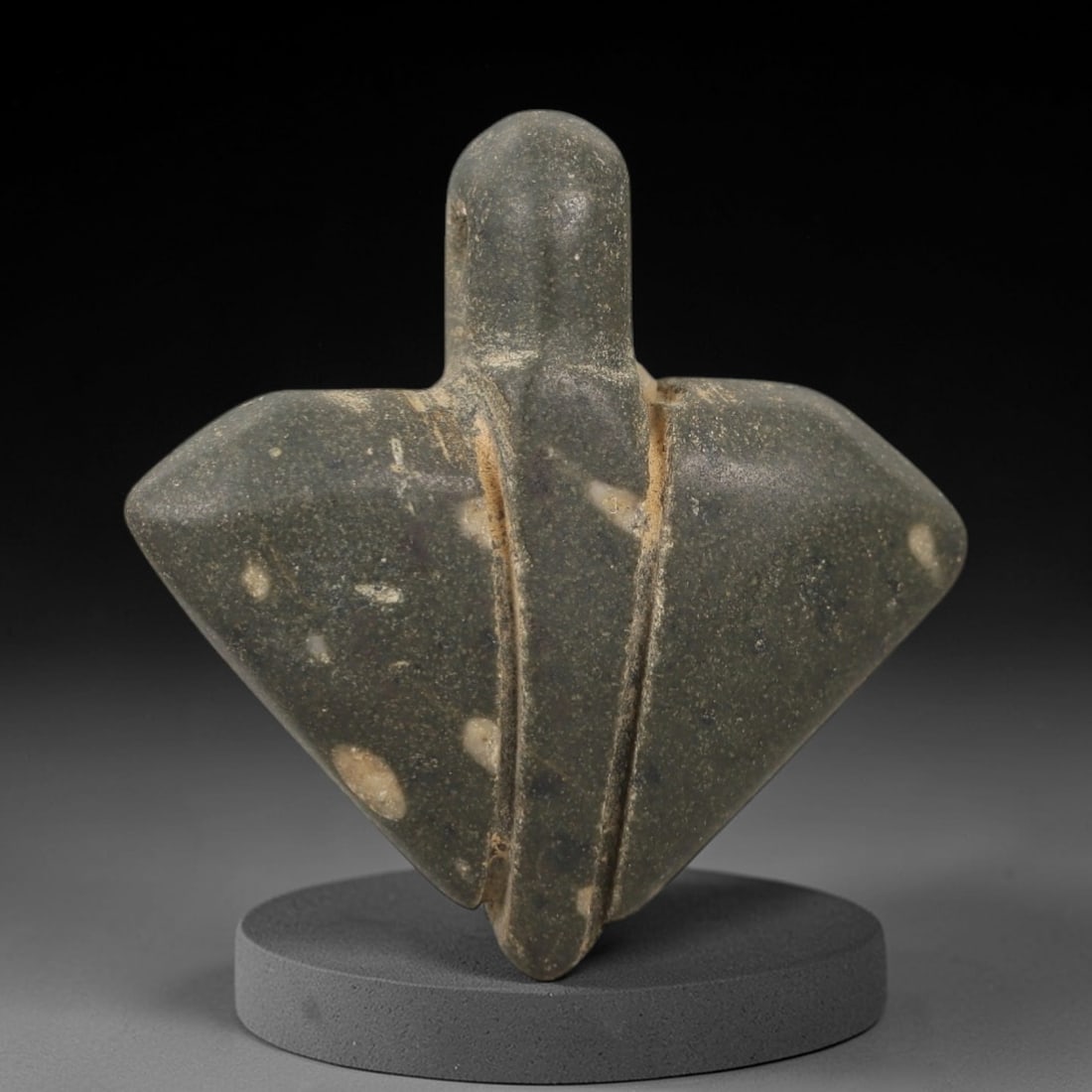 Ancient Egyptian Stone Bird Amulet - Falcon Carving, 47AG: Carved from stone, this ancient Egyptian bird amulet takes the form of a falcon, a sacred animal associated with the sun god Horus. The stylized carving features a compact body with incised details de