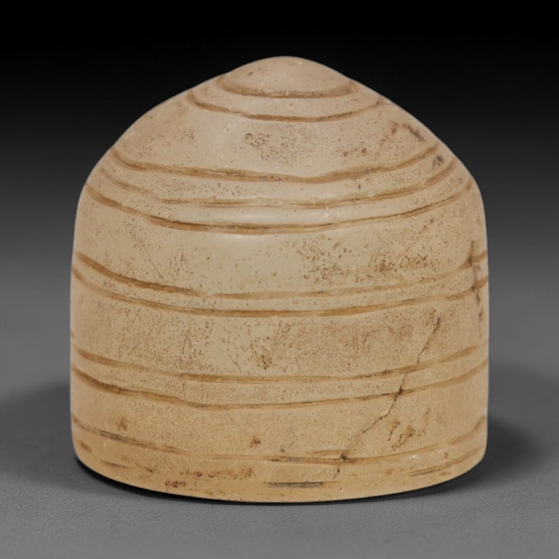 Ancient Rock Crystal Relic - Medieval Egyptian Conical Object, 64ZR: Carved from translucent pale rock crystal, this conical relic features concentric horizontal incised lines encircling its form, with a domed apex and flat base, reflecting medieval Egyptian stoneworki